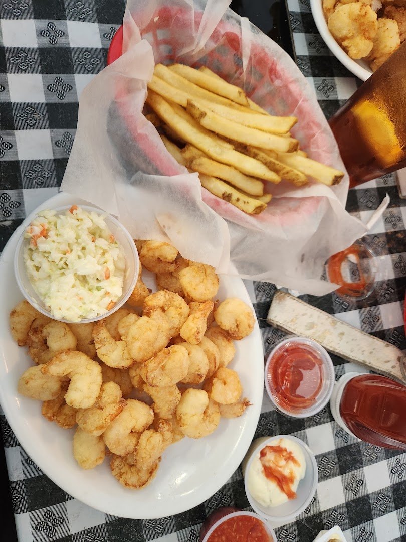 Fried shrimp and clams served in paper-lined baskets.